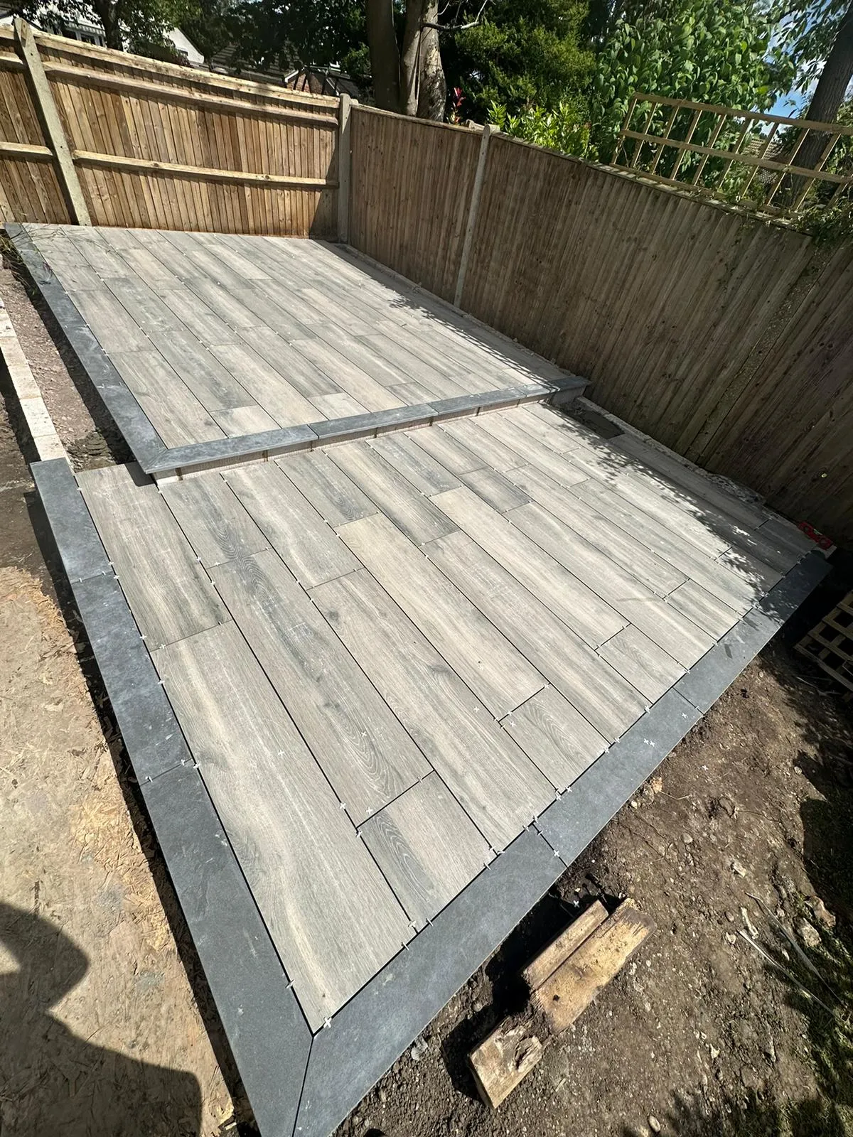a wooden deck being built in a backyard